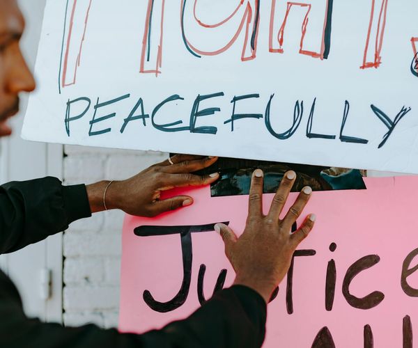 Person meditating peacefully in a calm environment.